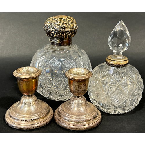 1174 - A cased set of six silver coffee spoons, a pair of squat candlesticks, a scent bottle with a silver ... 