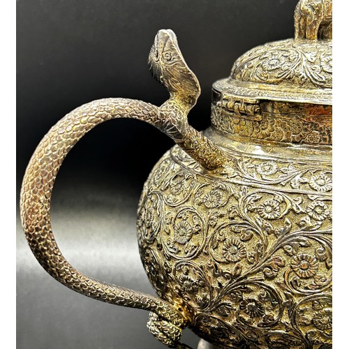 1240 - A three piece Indian silver metal tea service, heavily incised and engraved with an all over floral ... 