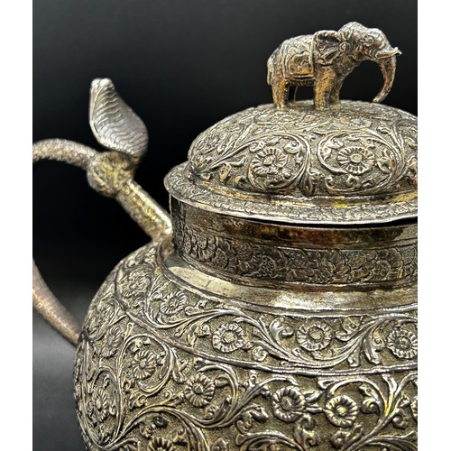 1240 - A three piece Indian silver metal tea service, heavily incised and engraved with an all over floral ... 