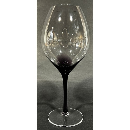 1101 - Six tall large wine glass with a purple stain leaking into the slender stems, a flat bottomed carafe... 