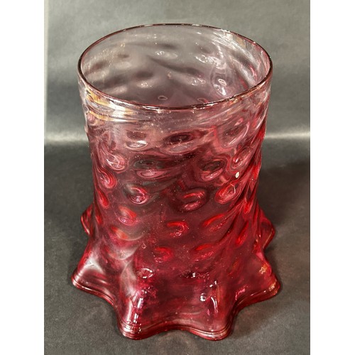 1104 - A 19th century cranberry crimped and dimpled glass oil lamp shade.23cm high.