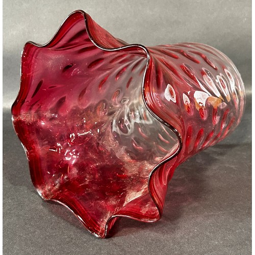 1104 - A 19th century cranberry crimped and dimpled glass oil lamp shade.23cm high.