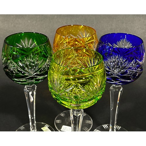 1107 - Four multicoloured cut glass hock glasses, blue, dark green, light green and amber, on slender hexag... 