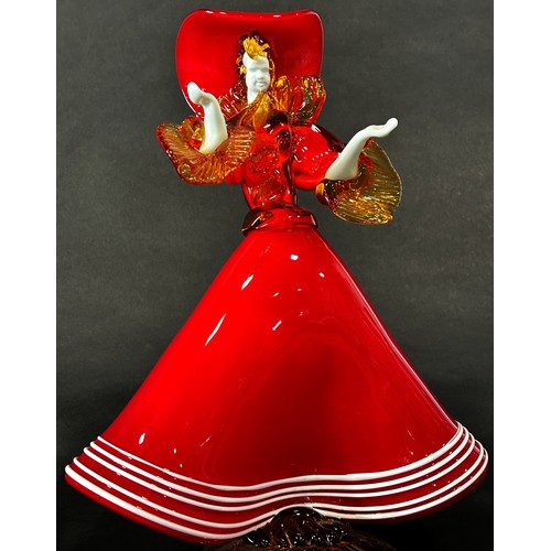 1108 - A Murano glass lady wearing a flared red A line dress with gold ruffled sleeves and flamboyant match... 