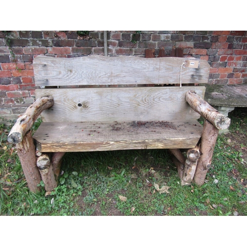 2043 - A rustic two seat garden bench with thick heavy boarded seat and back 146 cm wide
