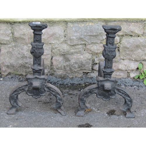 2106 - A large pair of country house cast iron fire dogs, 30cm high, 40cm deep.