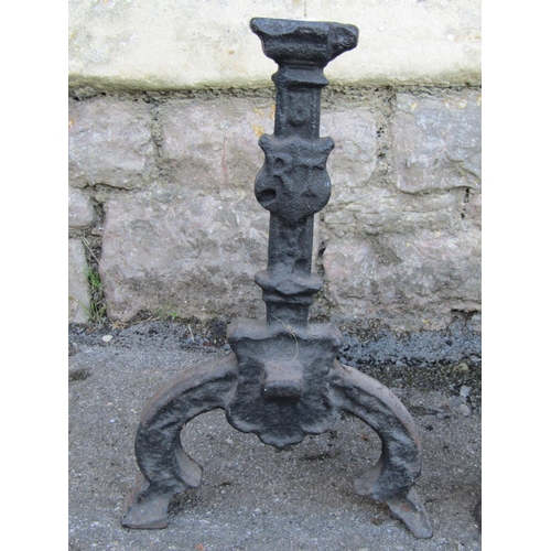 2106 - A large pair of country house cast iron fire dogs, 30cm high, 40cm deep.