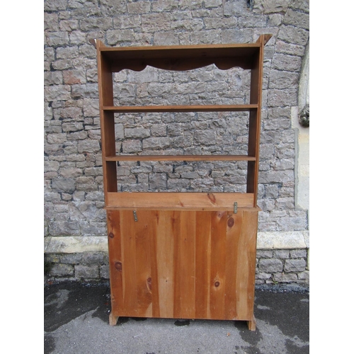 2200 - A small pine kitchen dresser, fitted with two drawers and a pair of panelled doors, below delft rack... 