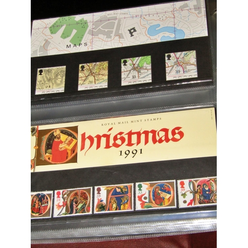 320 - Two Royal Mint presentation folios containing stamps from the early 1980s to c.2000, The Improved Po... 