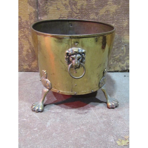 2152 - An oval brass coal bin with lions mask and ring handles and splayed paw feet, 42cm x 34cm x 30cm hig... 