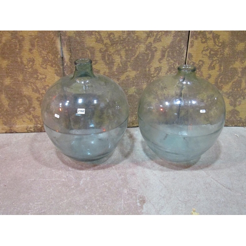 2162 - 2 similar vintage light green tinted glass carboys, 54cm high