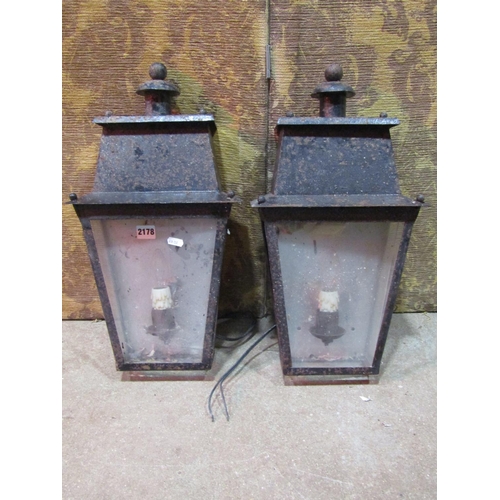 2178 - A pair of exterior wall mounted porch lanterns of tapered form with glazed panels (af)