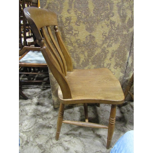 2190 - A harlequin set of elm seat lathe back kitchen chairs, with saddle shaped seats