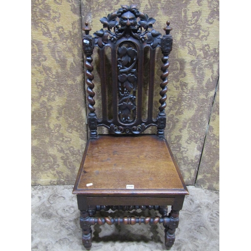 2191 - A Victorian carved oak chair, with solid seat, carved fruit and vine, green man and further carved d... 