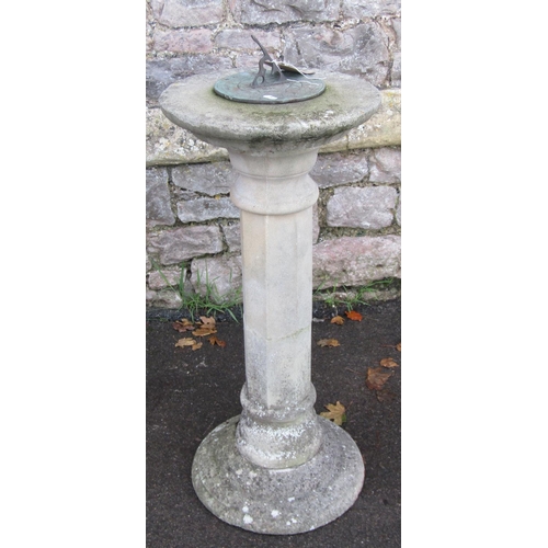 2001 - A weathered three sectional cast composition stone sundial  with octagonal pillar supporting a circu... 
