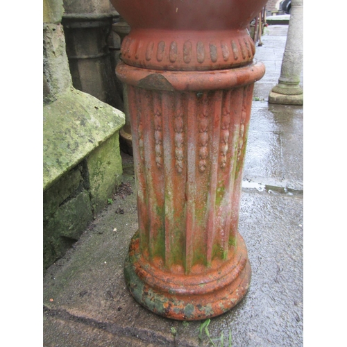 2008 - French terracotta urn with lions mask detail raised on a  fluted cylindrical pedestal, 34cm diameter... 