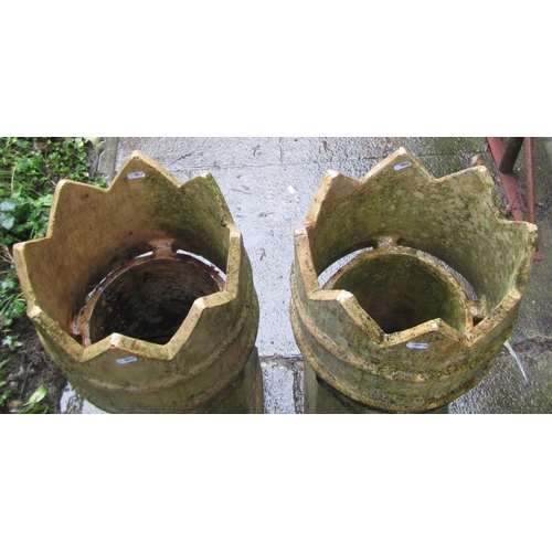 2010 - A pair of weathered buff coloured crown top chimney pots, 77cm high together with two further buff c... 