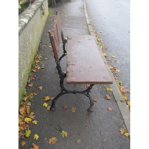 2012 - Small two seat cast iron garden bench with stained boarded seat and back, 120cm wide (af )