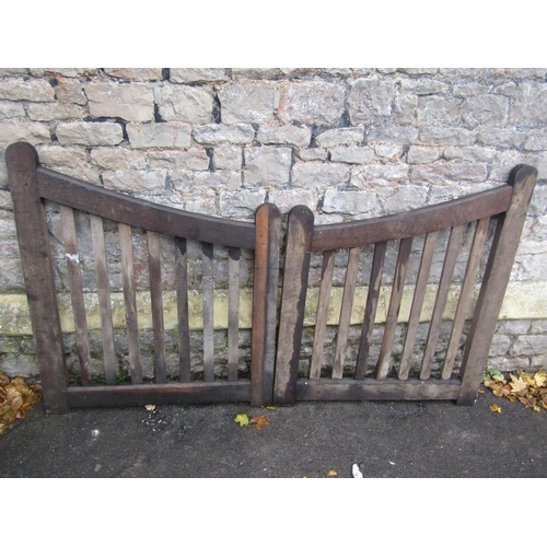 2021 - Pair of simple weathered oak entrance gates with open vertical slats, supporting down swept moulded ... 