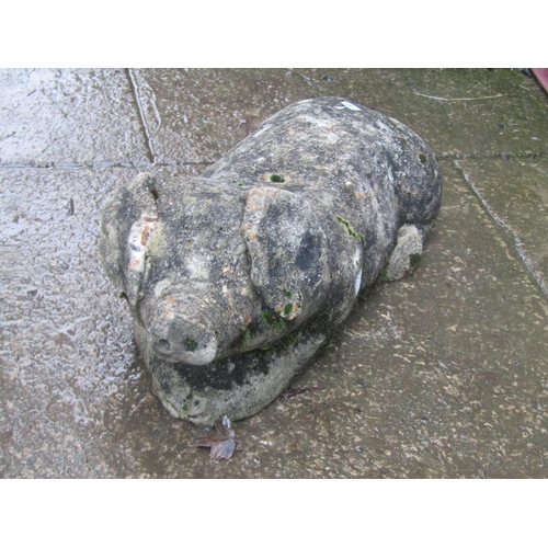 2032 - Novelty weathered cast composition stone recumbent pig, 50cm long x 19cm high (af)