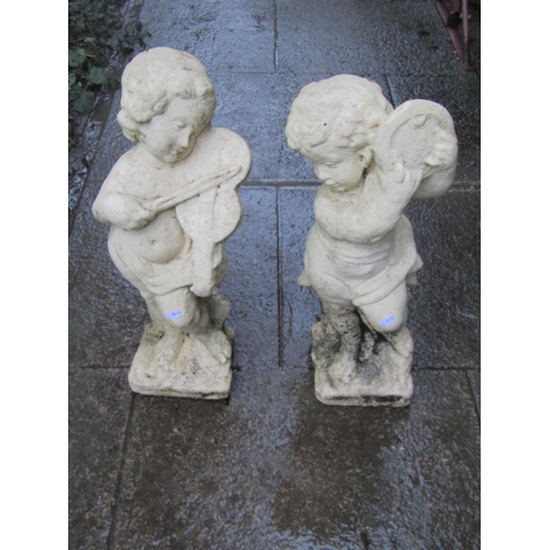2033 - Two painted cast composition stone ornaments in the form of cherub musicians, slight variation in he... 