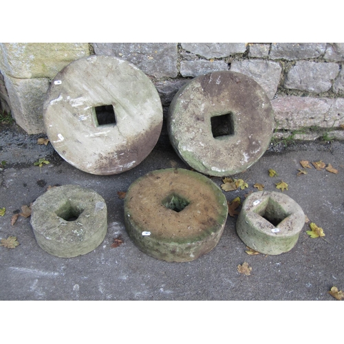 2087 - Five weathered mill stones of graduated size, the largest 45cm diameter, the smallest 20cm, varying ... 