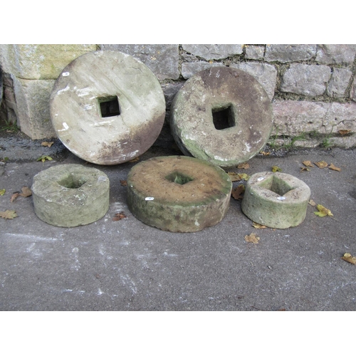 2087 - Five weathered mill stones of graduated size, the largest 45cm diameter, the smallest 20cm, varying ... 