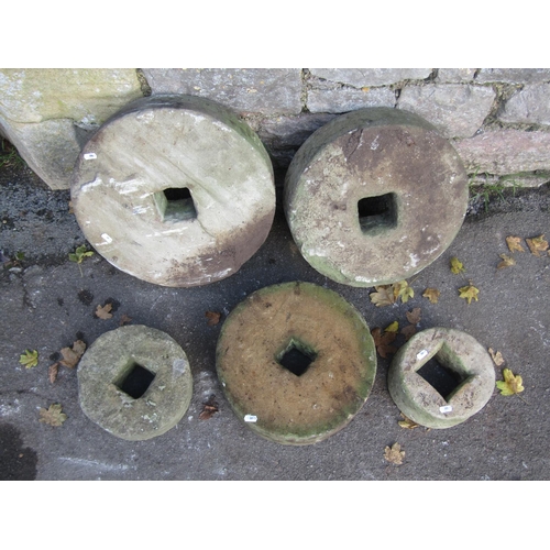 2087 - Five weathered mill stones of graduated size, the largest 45cm diameter, the smallest 20cm, varying ... 