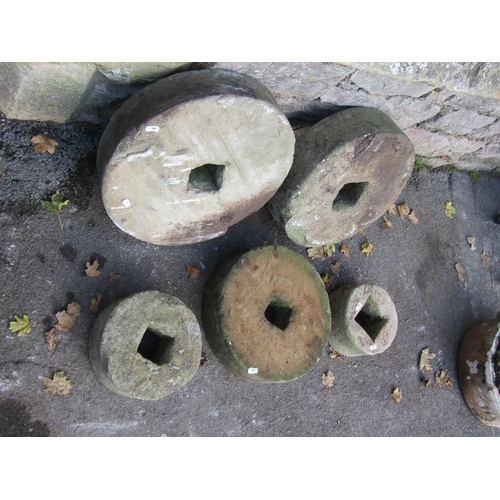 2087 - Five weathered mill stones of graduated size, the largest 45cm diameter, the smallest 20cm, varying ... 