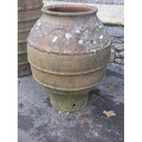 2091 - Two weathered Mediterranean terracotta urns of varying size and design, both with pressed banded det... 