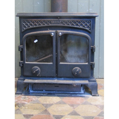 2102 - An Esse cast iron wood burner enclosed by a pair of arched panelled doors, flanked by geometric pane... 