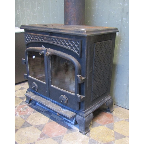 2102 - An Esse cast iron wood burner enclosed by a pair of arched panelled doors, flanked by geometric pane... 