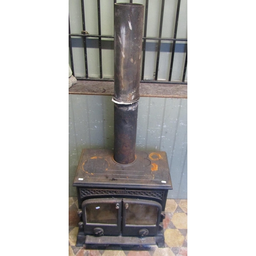 2102 - An Esse cast iron wood burner enclosed by a pair of arched panelled doors, flanked by geometric pane... 