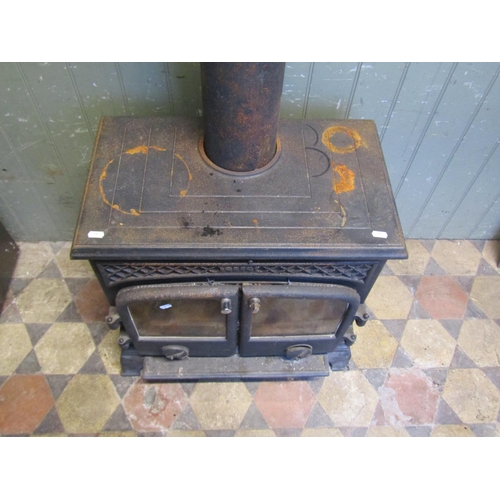 2102 - An Esse cast iron wood burner enclosed by a pair of arched panelled doors, flanked by geometric pane... 