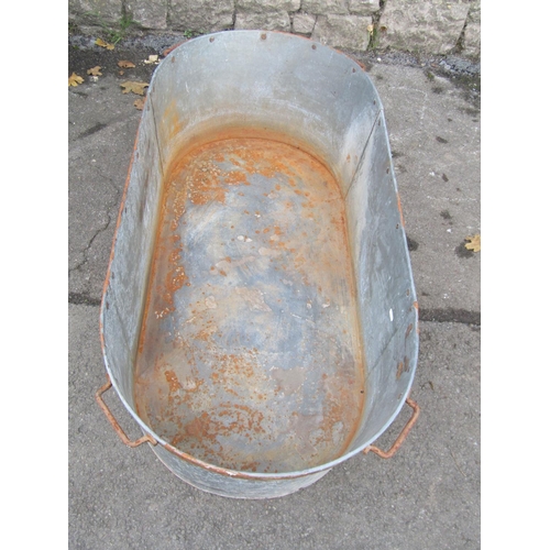 2116 - A vintage galvanised oval tub/bath with iron fittings, 120cm long x 55cm wide x 30cm deep