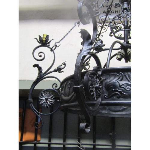 2122 - A good quality ironwork hanging ceiling light with decorative open scrollwork, flower head, leaf and... 