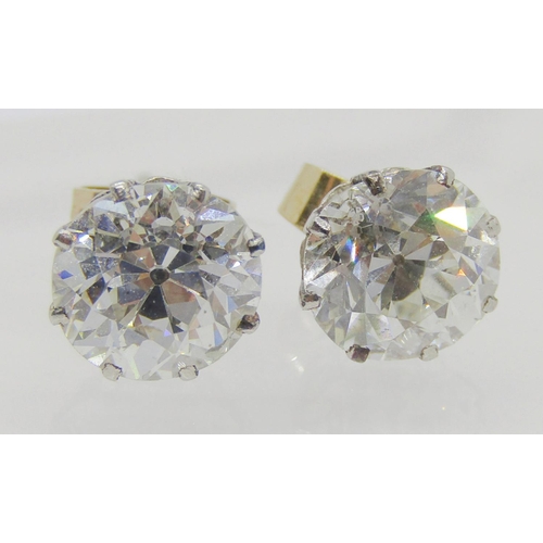 1304 - Exceptional pair of white metal diamond stud earrings in eight claw setting, the diamonds measuring ... 