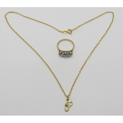 1344 - 9ct three stone dress ring and a 9ct diamond set 'P' pendant / charm hung from a 9ct chain necklace,... 