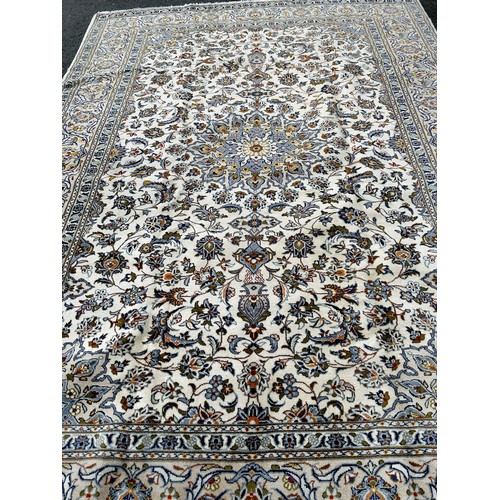 2720 - A large central Persian Kashan carpet with an all over floral pattern and floral borders,3.50m  x 2.... 