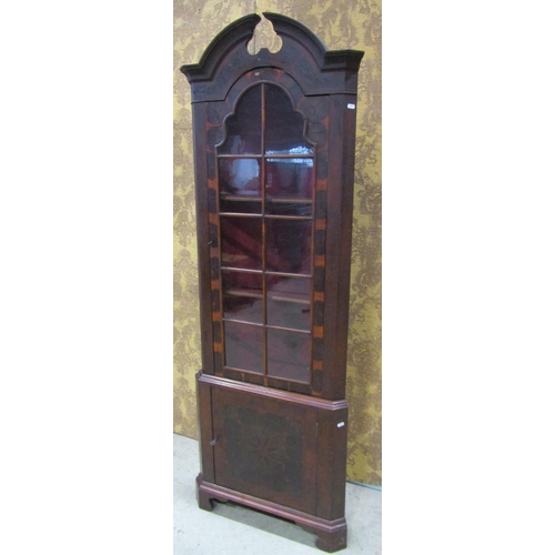 2201 - A Georgian style oyster veneered two sectional free standing corner cabinet, with broken arch pedime... 