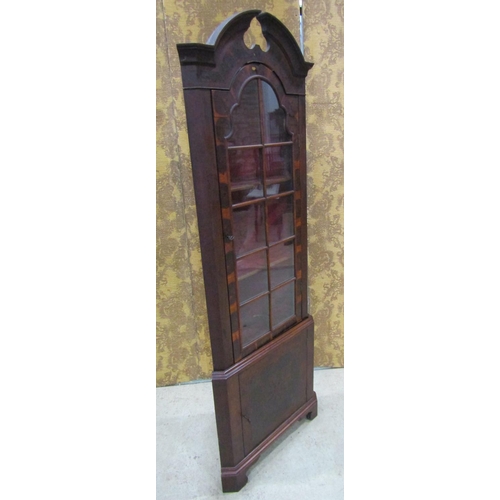 2201 - A Georgian style oyster veneered two sectional free standing corner cabinet, with broken arch pedime... 