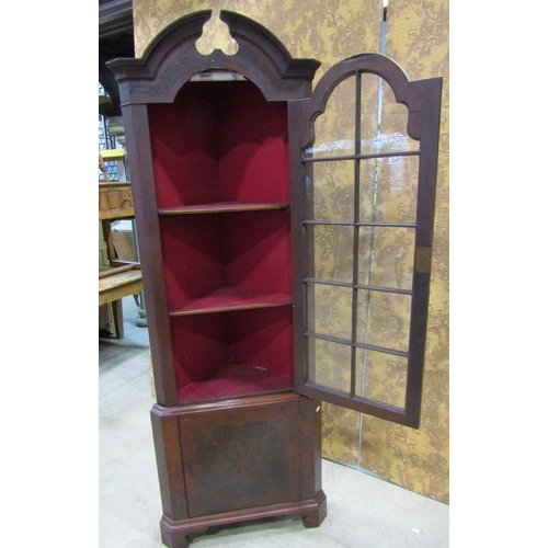 2201 - A Georgian style oyster veneered two sectional free standing corner cabinet, with broken arch pedime... 