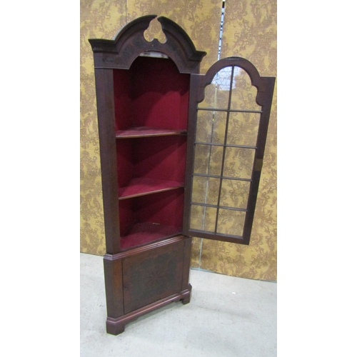 2201 - A Georgian style oyster veneered two sectional free standing corner cabinet, with broken arch pedime... 