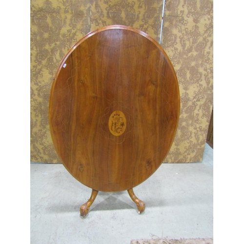 2208 - Victorian oval walnut breakfast table with inlaid detail, raised on a central turned pillar and scro... 