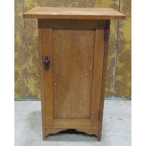 2214 - An Arts & Crafts style oak bedside cupboard, the rectangular over hanging top over a rectangular pan... 