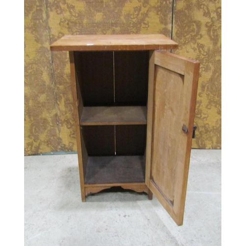 2214 - An Arts & Crafts style oak bedside cupboard, the rectangular over hanging top over a rectangular pan... 