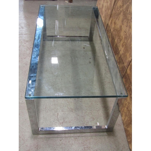 2221 - A modernist low occasional table of rectangular form, raised on chrome supports with tempered glass ... 