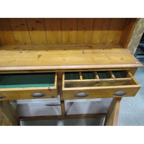 2236 - Rustic stripped pine kitchen dresser, the base enclosed by a pair of twin panelled doors beneath two... 