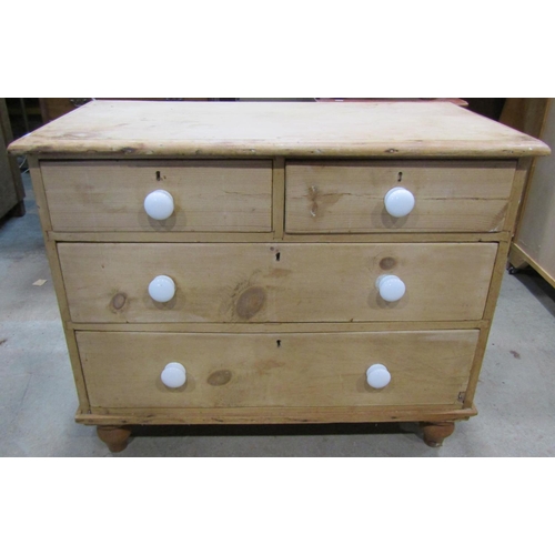 2242 - A Victorian stripped pine chest of two long and two short drawers set on turned feet, 95cm wide x 51... 