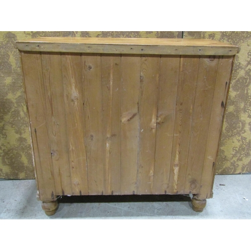 2243 - A stripped and waxed pine chest of three long and two short drawers, raised on turned supports, 105c... 